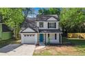 Charming two-story home with white siding, black shutters, and a well-manicured front yard at 3527 Clare Cottage Sw Trce, Marietta, GA 30008