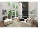 Bright living room with tall windows, fireplace with built-ins and comfortable seating at 3930 Clifton Hill Court #15, Cumming, GA 30040