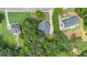An aerial shot showing the property's layout, surrounded by mature trees, and neighboring homes at 1418 Brighton Pl, Loganville, GA 30052