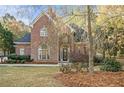 A charming brick home with beautiful landscaping and mature trees at 1418 Brighton Pl, Loganville, GA 30052