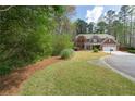 Beautifully landscaped front yard with mature trees surrounding the classic brick home at 2251 Everleigh Ln, Marietta, GA 30064