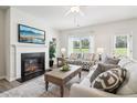 Bright living room with fireplace, hardwood floors, ceiling fan and neutral decor at 3623 Squires Park Ln, Loganville, GA 30052