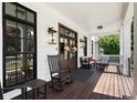 Inviting front porch featuring rocking chairs, a seating area, and stylish lighting fixtures at 542 Orme Ne Cir, Atlanta, GA 30306