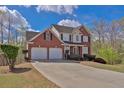 Lovely two-story brick home with a two-car garage and attractive landscaping at 705 Sunset Ridge Se Ln, Lawrenceville, GA 30045