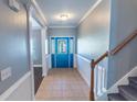Home foyer features a blue front door with decorative glass and tiled flooring at 170 Shoal Park Dr, Mcdonough, GA 30252