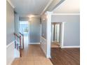 Inviting home hallway with neutral paint, tiled floors and elegant white trim details at 170 Shoal Park Dr, Mcdonough, GA 30252