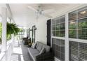 Covered porch with comfortable seating offers a relaxing outdoor space, complete with ceiling fans and lush greenery at 4960 Old Yorkville Rd, Dallas, GA 30157