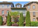 Attractive townhome exterior with brick and siding, complemented by mature landscaping and a blue sky at 2116 Gorman Se Grv, Atlanta, GA 30316