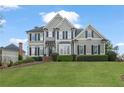 Charming two-story home with manicured lawn and traditional design elements at 295 Sagamore Nw Cv, Sugar Hill, GA 30518