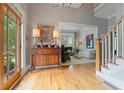 Inviting foyer with hardwood floors, natural light, and a view into the living room at 295 Sagamore Nw Cv, Sugar Hill, GA 30518