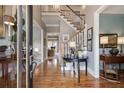 Inviting foyer featuring hardwood floors, staircase, and elegant decor at 295 Sagamore Nw Cv, Sugar Hill, GA 30518