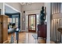 Elegant foyer featuring hardwood floors, chandelier, and a glass front door, creating a grand entrance at 295 Sagamore Nw Cv, Sugar Hill, GA 30518