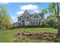 Charming two-story home with manicured lawn and lush landscaping at 295 Sagamore Nw Cv, Sugar Hill, GA 30518