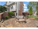 Inviting outdoor firepit area with stone patio and comfortable seating at 295 Sagamore Nw Cv, Sugar Hill, GA 30518
