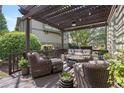 Relaxing outdoor patio with pergola, comfortable seating, and stylish decor at 295 Sagamore Nw Cv, Sugar Hill, GA 30518