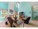 Inviting living room features high ceilings, a fireplace, and ample natural light at 545 Goldfinch Way, Stockbridge, GA 30281
