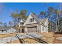 Charming two-story home featuring white siding, an attached garage, and ample parking on the concrete driveway at 6091 Wayfarer Dr, Villa Rica, GA 30180