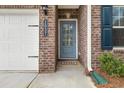 Close-up of the front entrance, showing the brick facade and blue door with house number at 1037 Devon Dr, Acworth, GA 30102