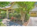 Beautiful home with landscaped yard, sidewalk leading to the front door, and a garage on the side at 1714 Parkhill Dr, Decatur, GA 30032