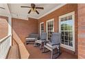 Relaxing front porch with rocking chairs, bench, and brick flooring at 1414 Lynchburg Trce, Grayson, GA 30017