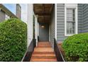 Charming front porch features brick steps, iron railings, and mature landscaping at 1456 Hedgewood Nw Ln, Kennesaw, GA 30152
