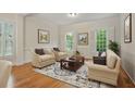 Cozy living room with comfortable seating, hardwood floors, and bright windows at 1456 Hedgewood Nw Ln, Kennesaw, GA 30152