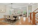Open-concept living and dining area with hardwood floors and abundant natural light at 1456 Hedgewood Nw Ln, Kennesaw, GA 30152