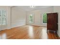 Bright living room with hardwood floors, white trim, and lots of natural light at 1456 Hedgewood Nw Ln, Kennesaw, GA 30152