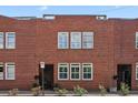Charming brick townhouse showcasing a classic facade with symmetrically arranged windows and pedestrian gate at 230 Bradberry Sw St # 9, Atlanta, GA 30313