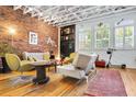 Stylish living room with exposed brick wall, hardwood floors, and ample natural light at 230 Bradberry Sw St # 9, Atlanta, GA 30313