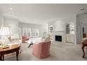 Bright living room featuring a fireplace, built-in shelving, and large windows offering plenty of natural light at 28315 Plantation Ne Dr, Atlanta, GA 30324