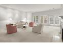 Bright, open living room with neutral carpet, fireplace, and large windows that flood the space with natural light at 28315 Plantation Ne Dr, Atlanta, GA 30324