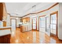 Sunlit kitchen with hardwood floors, an island, pendant lighting, and modern appliances for a stylish and functional space at 1135 Azalea Cir, Conyers, GA 30013