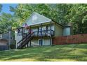 Welcoming two-story home with a covered porch, lush lawn, and wood privacy fence at 260 Sterling Dr, Powder Springs, GA 30127
