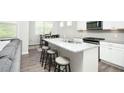 Modern kitchen with granite countertops, stainless steel appliances, and a breakfast bar with seating at 3080 W Jackson Way, Austell, GA 30106