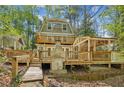 Multi-level deck with covered area perfect for outdoor entertaining, surrounded by lush greenery at 3125 Lakeside Dr, Cumming, GA 30041