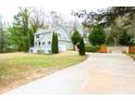 Spacious home with a long drive and well-maintained lawn, set amongst mature trees and natural surroundings at 1206 Park Place Dr, Jonesboro, GA 30236