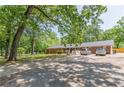 Charming brick home surrounded by lush greenery and mature trees with spacious parking at 5150 Scofield Rd, College Park, GA 30349