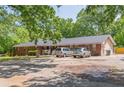 Charming brick home with spacious parking and mature trees, near green lawn at 5150 Scofield Rd, College Park, GA 30349