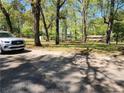 A home with an expansive front yard and mature trees adding charm to the property at 5150 Scofield Rd, College Park, GA 30349