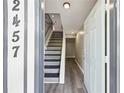 Inviting entryway featuring modern flooring and a staircase with updated railings at 2457 Shiloh Dr, Decatur, GA 30034