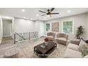 Bright living room boasts updated ceiling fan and neutral finishes at 2457 Shiloh Dr, Decatur, GA 30034