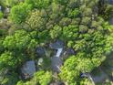 Aerial view of a secluded property surrounded by lush green trees at 3300 Old Mill Ct, Decatur, GA 30033
