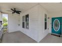 Inviting covered front porch with a ceiling fan and a vibrant teal front door at 4603 Parkway Circle, Atlanta, GA 30349