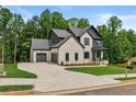 Charming two-story home with brick, siding, and a two car garage at 6132 Hutchins Dr, Buford, GA 30518