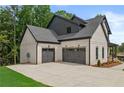 View of a two car garage attached to a home at 6132 Hutchins Dr, Buford, GA 30518