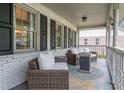 Covered porch with comfortable seating and a view of the surrounding neighborhood at 1337 Frontier Trl, Sugar Hill, GA 30518