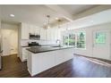 Modern kitchen featuring an island with dark countertops, white cabinets, and stainless steel appliances at 2867 Payton Ne Rd, Atlanta, GA 30345