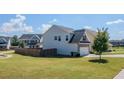 View of the home's backyard featuring a lush lawn and a privacy fence at 113 Cottage Walk, Cartersville, GA 30121