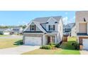 Charming two-story home with stone accents, a two-car garage, and a well-manicured lawn at 113 Cottage Walk, Cartersville, GA 30121
